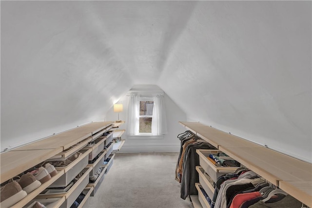 spacious closet with lofted ceiling and carpet floors