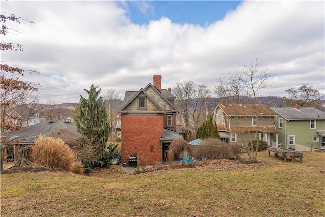 rear view of house with a yard