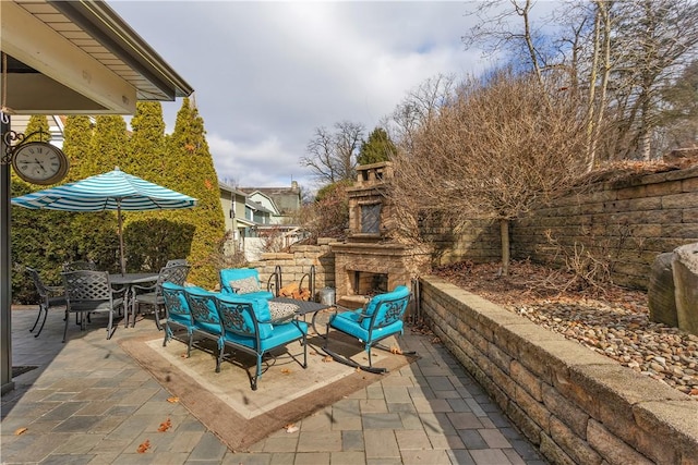 view of patio / terrace with an outdoor stone fireplace