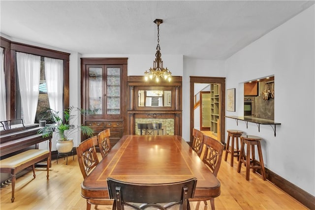 dining area featuring a notable chandelier and light wood-type flooring