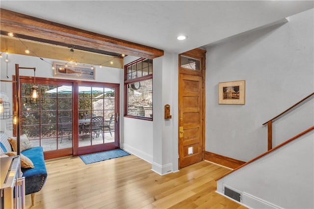 entryway with beamed ceiling and hardwood / wood-style flooring