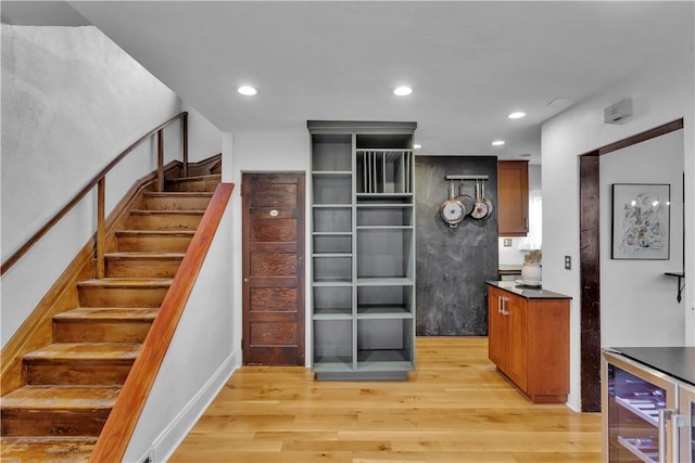 kitchen with beverage cooler and light hardwood / wood-style floors