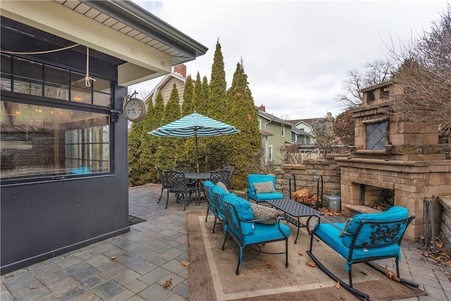 view of patio featuring an outdoor stone fireplace