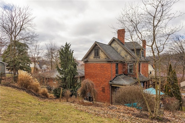 view of property exterior with a lawn