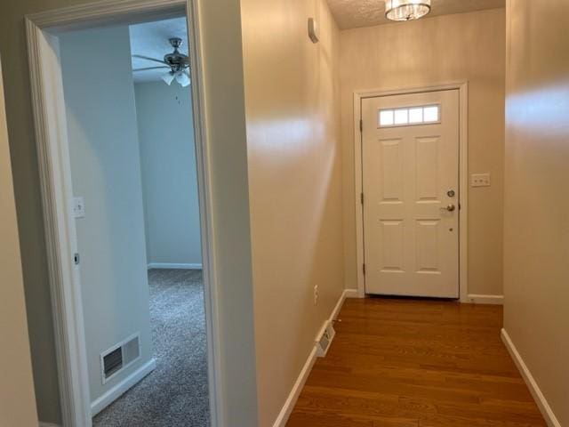 doorway to outside with dark hardwood / wood-style floors and ceiling fan