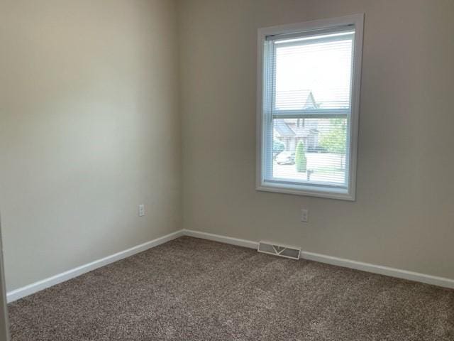 spare room featuring carpet