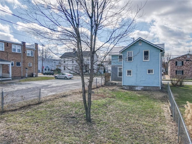 view of side of property with a yard