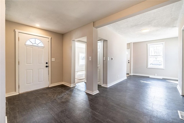 entryway featuring dark hardwood / wood-style floors and a textured ceiling