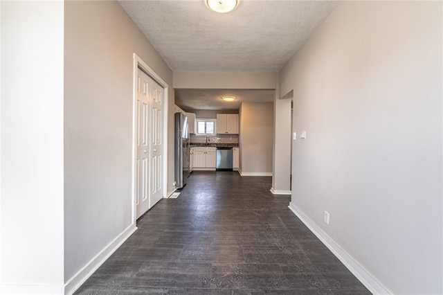 hall featuring dark hardwood / wood-style flooring and a textured ceiling