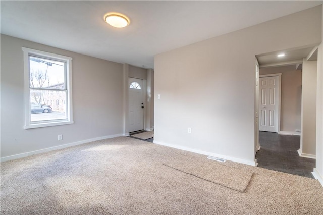 empty room featuring dark carpet