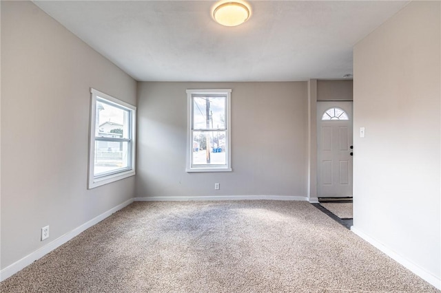 view of carpeted foyer entrance