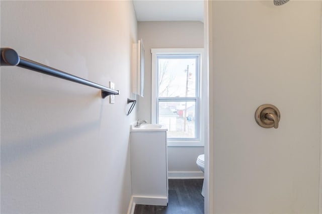 bathroom featuring vanity, toilet, and hardwood / wood-style floors