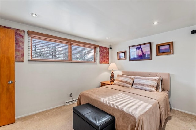 bedroom featuring a baseboard heating unit and light carpet