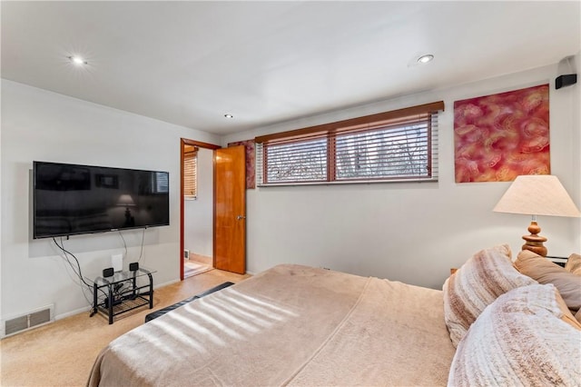 bedroom featuring light carpet