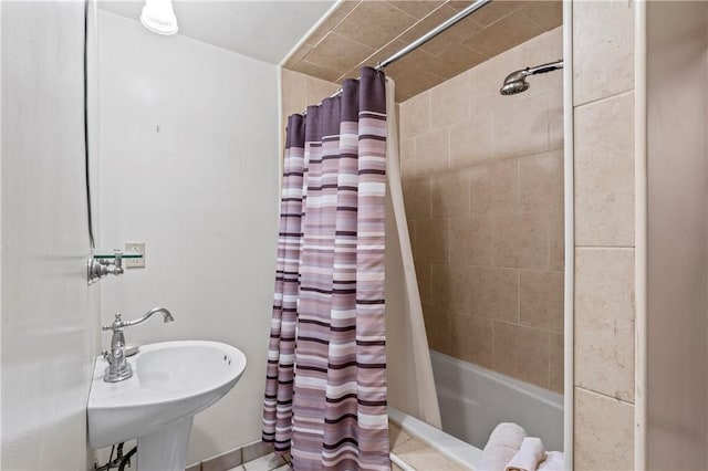 bathroom with sink and shower / bath combo with shower curtain