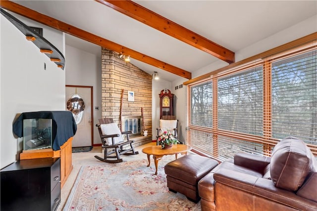 carpeted living room featuring a stone fireplace and lofted ceiling with beams