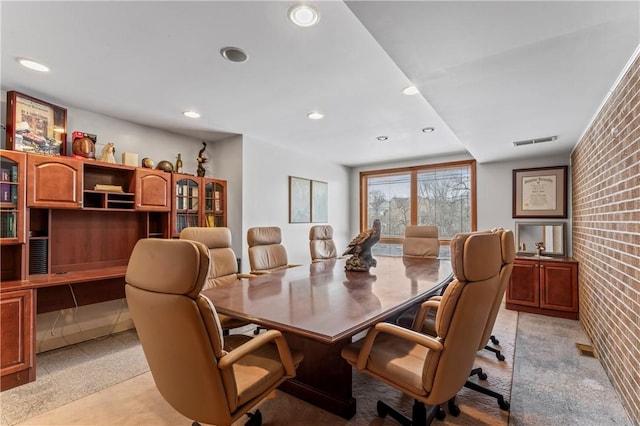 dining area featuring brick wall