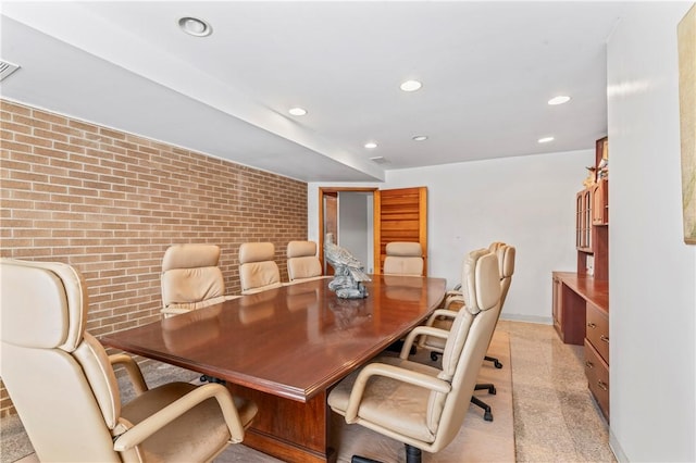 dining space with brick wall