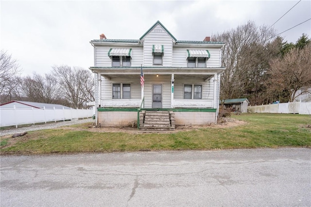 view of property with a porch and a front lawn