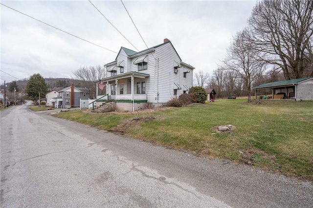 view of home's exterior with a porch and a lawn