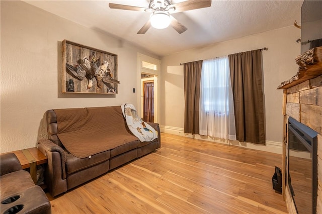 living room with ceiling fan and light wood-type flooring