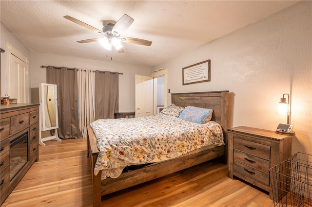 bedroom with ceiling fan and light wood-type flooring