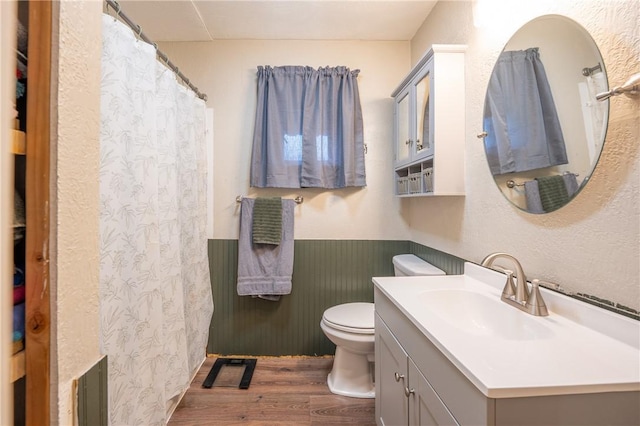 bathroom featuring hardwood / wood-style flooring, vanity, and toilet