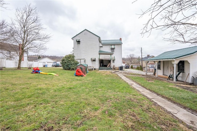 rear view of property featuring a yard and central air condition unit