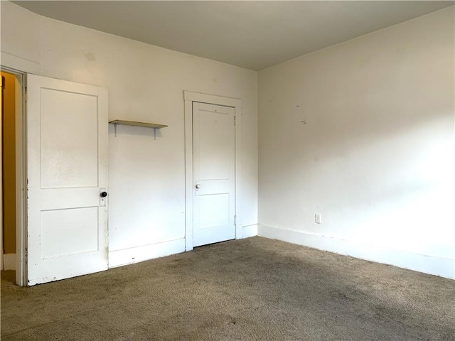 unfurnished bedroom featuring dark colored carpet