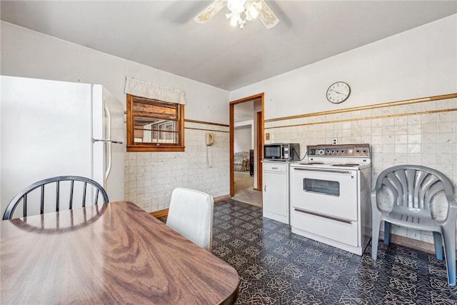 kitchen with ceiling fan, tile walls, and white appliances