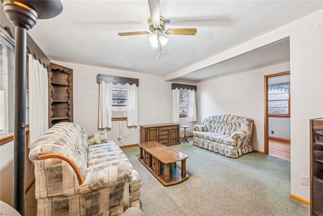 carpeted living room featuring ceiling fan