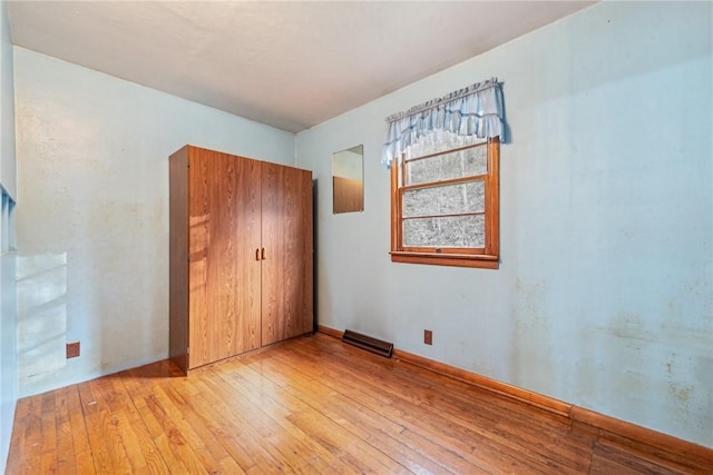 unfurnished bedroom featuring a closet and light hardwood / wood-style flooring