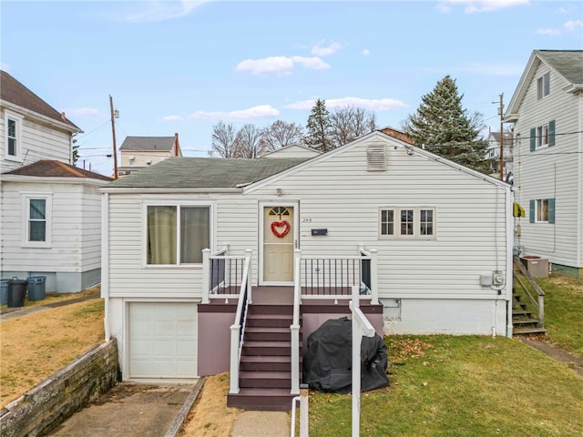 view of front of house with a garage and a front yard