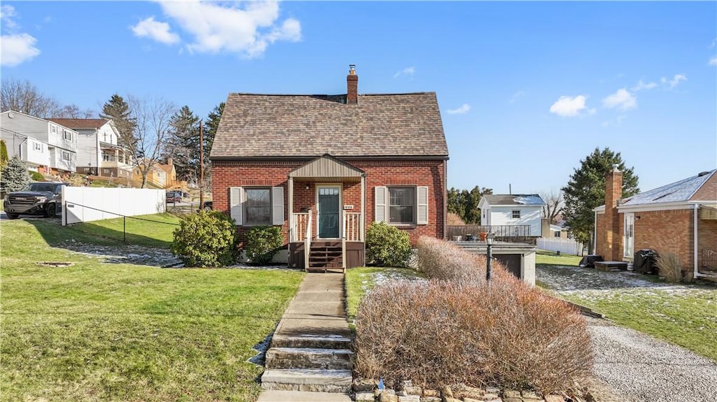 bungalow-style house with a front lawn