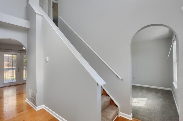 stairs featuring hardwood / wood-style floors