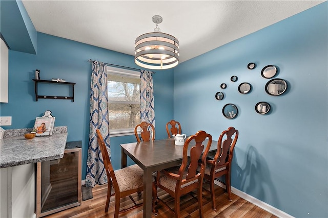 dining area with a notable chandelier and wood-type flooring