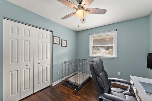 office area with ceiling fan and dark hardwood / wood-style floors