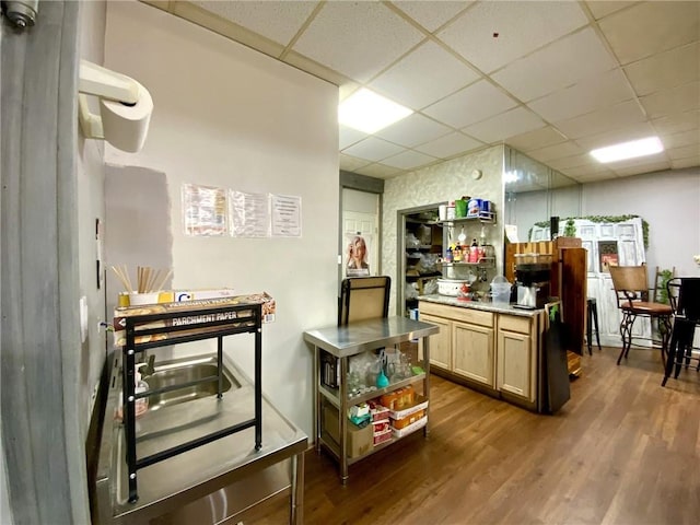 kitchen featuring a paneled ceiling, dark hardwood / wood-style floors, and light brown cabinetry