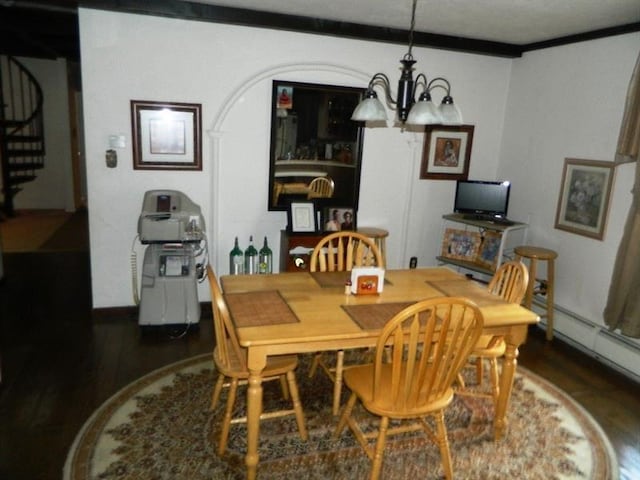 dining room featuring a notable chandelier, crown molding, and dark hardwood / wood-style floors