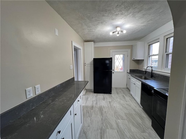 kitchen with white cabinetry, sink, dark stone counters, and black appliances