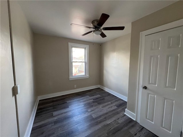 spare room featuring ceiling fan and dark hardwood / wood-style flooring