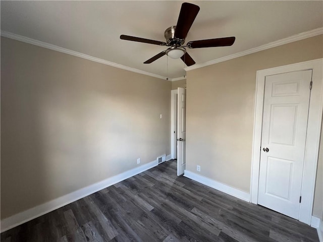 empty room featuring ornamental molding, dark hardwood / wood-style floors, and ceiling fan