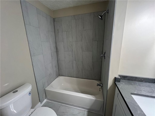 full bathroom featuring vanity, tiled shower / bath combo, a textured ceiling, and toilet