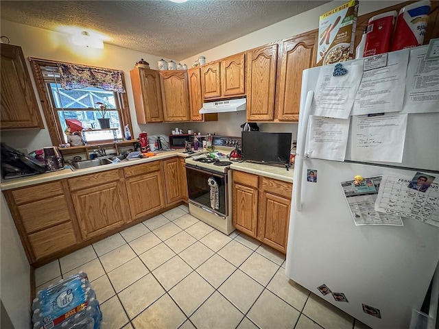 716-718 Hettie Way, City Of But Sw, PA 16001 - kitchen with white appliances, under cabinet range hood, light countertops, light tile patterned floors, and a sink