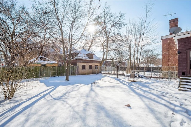 view of yard layered in snow