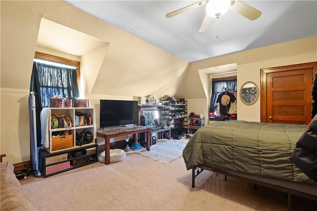 carpeted bedroom with lofted ceiling and ceiling fan