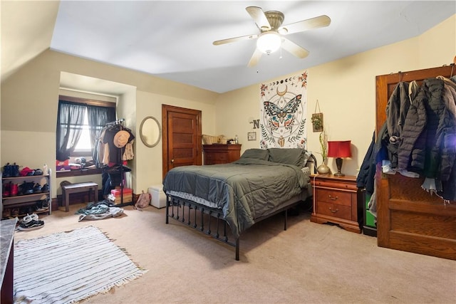 bedroom with light carpet, lofted ceiling, and ceiling fan