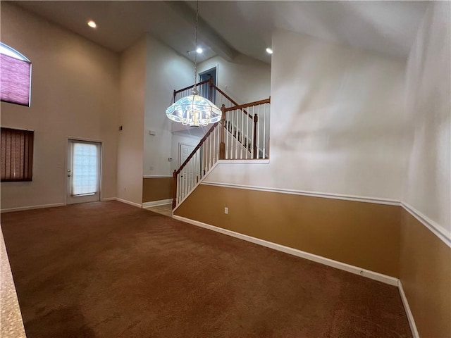 interior space with an inviting chandelier, high vaulted ceiling, beamed ceiling, and carpet