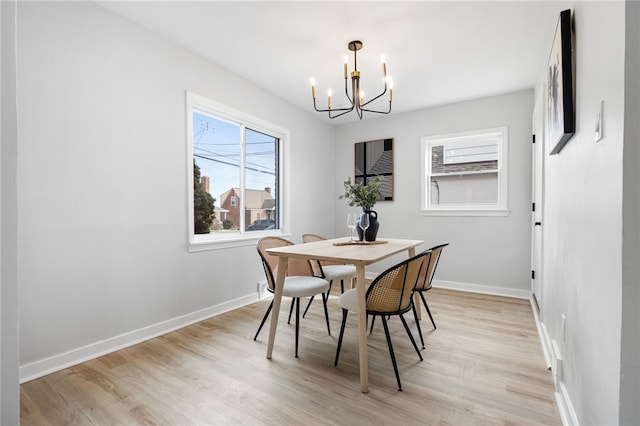 dining space featuring a chandelier and light hardwood / wood-style flooring