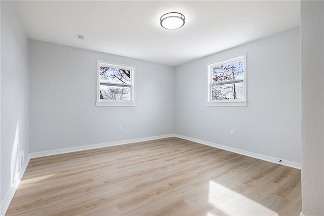 unfurnished room featuring a wealth of natural light and light wood-type flooring